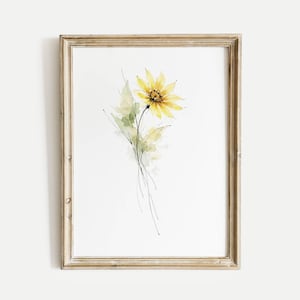 May include: A framed watercolor print featuring a yellow sunflower with green leaves and delicate black lines. The artwork is set against a white background, and the frame is a light, natural wood color.