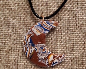 Copper moon with blue and white designs handmade polymer clay necklace