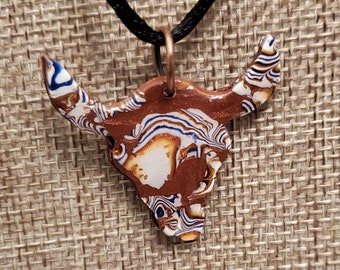 Copper bull with blue and white designs handmade polymer clay necklace