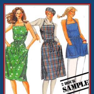 May include: A sewing pattern illustration featuring three apron styles: a green floral apron with pockets, a blue and red plaid apron with a matching beret, and a solid blue apron with large pockets. The text 2 HOUR SAMPLE is printed in black.