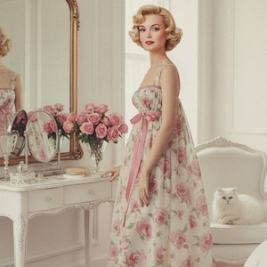 May include: A vintage-style dress with a floral print of pink roses and a matching pink ribbon. The dress is worn with pink heels. A white cat sits on a chair in the background. The image also includes a vanity with a mirror and a vase of pink roses.