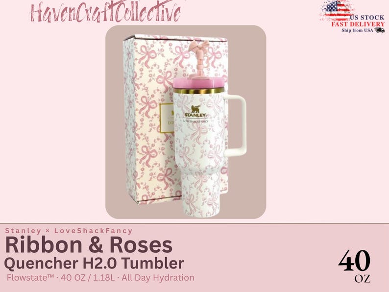 May include: A white Stanley Quencher H2.0 tumbler with a pink ribbon and rose pattern, featuring a matching pink lid, a handle, and a straw topper. The tumbler is displayed next to its original box, which shares the same pink and white ribbon design.