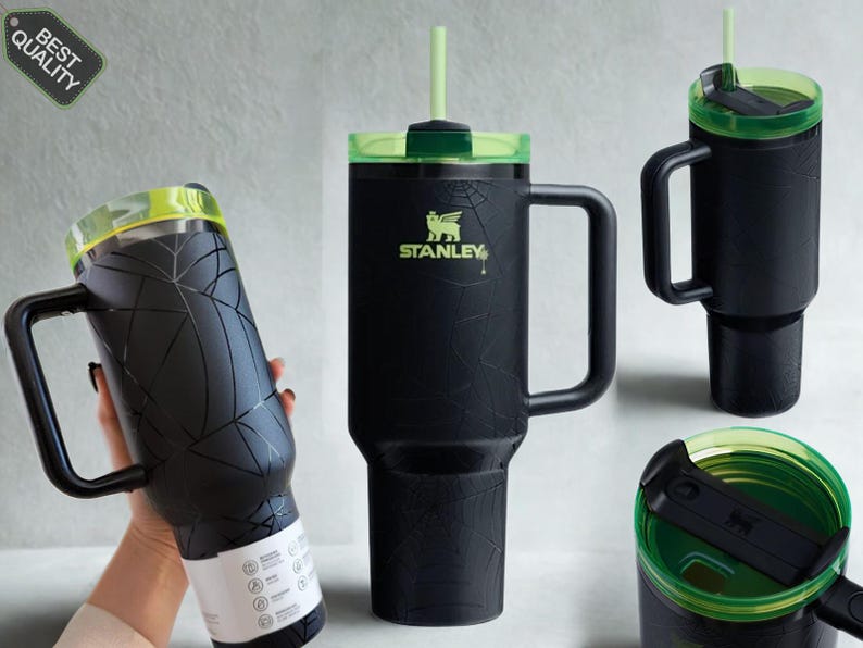 May include: A matte black Stanley tumbler featuring a subtle spiderweb pattern, a sturdy side handle, and a translucent neon green lid with a matching straw. The cup displays the Stanley logo in neon green and includes a black sliding lid mechanism.