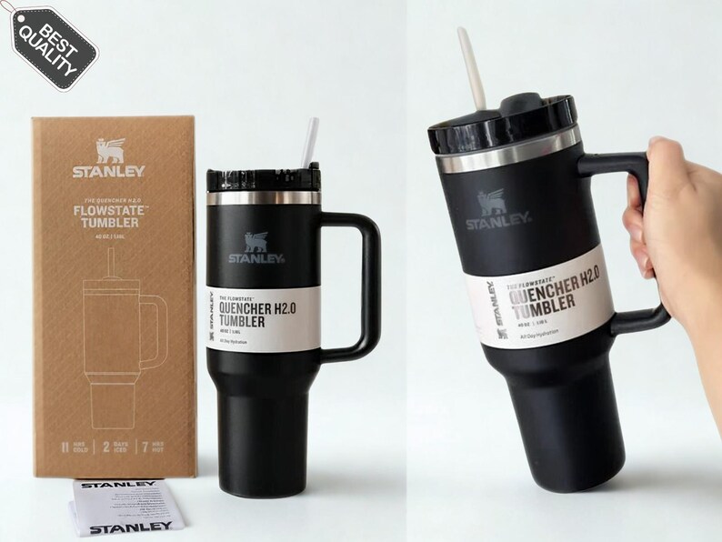 May include: A matte black Stanley Flowstate Quencher H2.0 tumbler with a handle, a black lid, and a white straw. The tumbler features a white product label and is shown next to its brown cardboard packaging box, which displays the Stanley logo and text.
