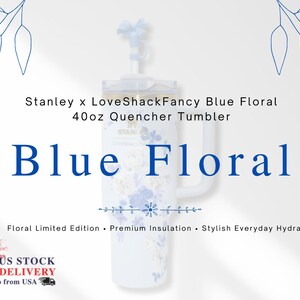 May include: A white 40oz Stanley Quencher tumbler with a blue floral design. The tumbler has a handle and a lid with a straw. The text "Blue Floral" is displayed in large blue letters. The text "Stanley x LoveShackFancy" is also visible.