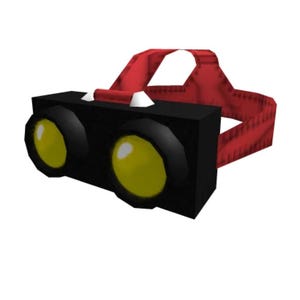 Könnte beinhalten: Eine schwarze Stirnlampe mit zwei gelben Linsen und einem roten Riemen. Die Stirnlampe hat einen rechteckigen Körper und einen gebogenen Riemen für sicheres Tragen. Die runden Linsen strahlen gelb.