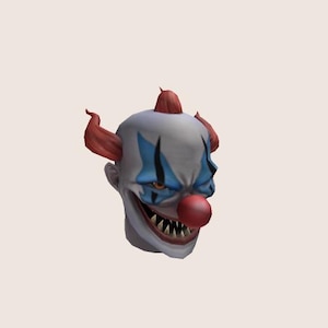 May include: A creepy clown head with red hair, blue and white makeup, and a large red nose. The clown has a wide, toothy grin.