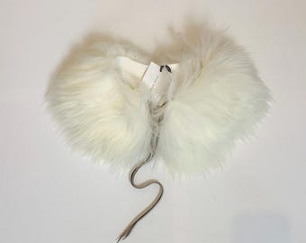 May include: White faux fur collar with a black ribbon tie.