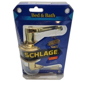 May include: A gold-colored Schlage door handle with a lever design. The packaging says "Bed & Bath" and "Full Warranty".