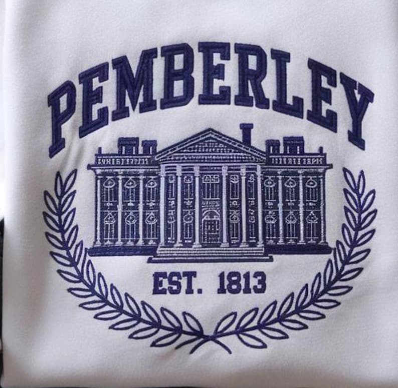 May include: A white embroidered sweatshirt with the text "Pemberley Est. 1813" in navy blue. The design features a white silhouette of a large house with columns and windows.