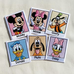 May include: Embroidered patches featuring beloved Disney characters: Mickey, Minnie, Goofy, Donald, Pluto, and Daisy. Each patch has a white border and the character's name below. The patches showcase vibrant colors and detailed stitching.