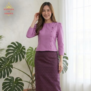 May include: A lavender long-sleeved blouse with a round neckline and a side-button closure featuring five matching buttons, paired with a dark purple ankle-length skirt that has a repeating geometric diamond pattern across the entire fabric surface.