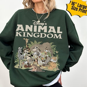 May include: Dark green sweatshirt featuring the text "Disney's Animal Kingdom" above a graphic of Disney characters including Mickey Mouse, Donald Duck, and Goofy. The graphic is a 16-inch large size print.
