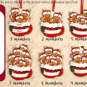 May include: Six Christmas ornaments shaped like red mugs filled with white frosting and varying numbers of gingerbread people wearing Santa hats. Each mug features a red ribbon for hanging and text placeholders labeled Year and Text.