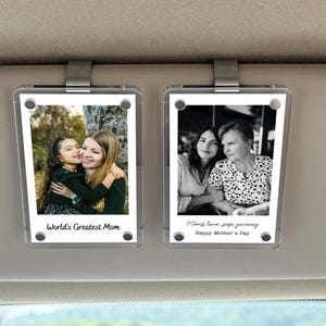 May include: Two clear acrylic photo car visor clips, each with a photograph. One shows a mother and child with the text "World's Greatest Mom." The other shows two women with the text "Mom's love, safe journey Happy Mother's Day."
