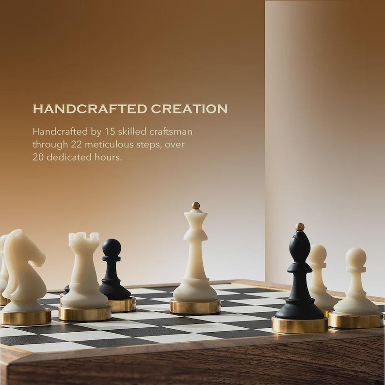 May include: A handcrafted chess set with white and black pieces on a checkered board. The pieces have gold-colored bases. The text "HANDCRAFTED CREATION" is visible in the background.