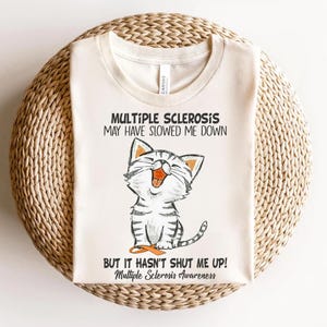 a white t - shirt with a picture of a cat saying multiple scleross
