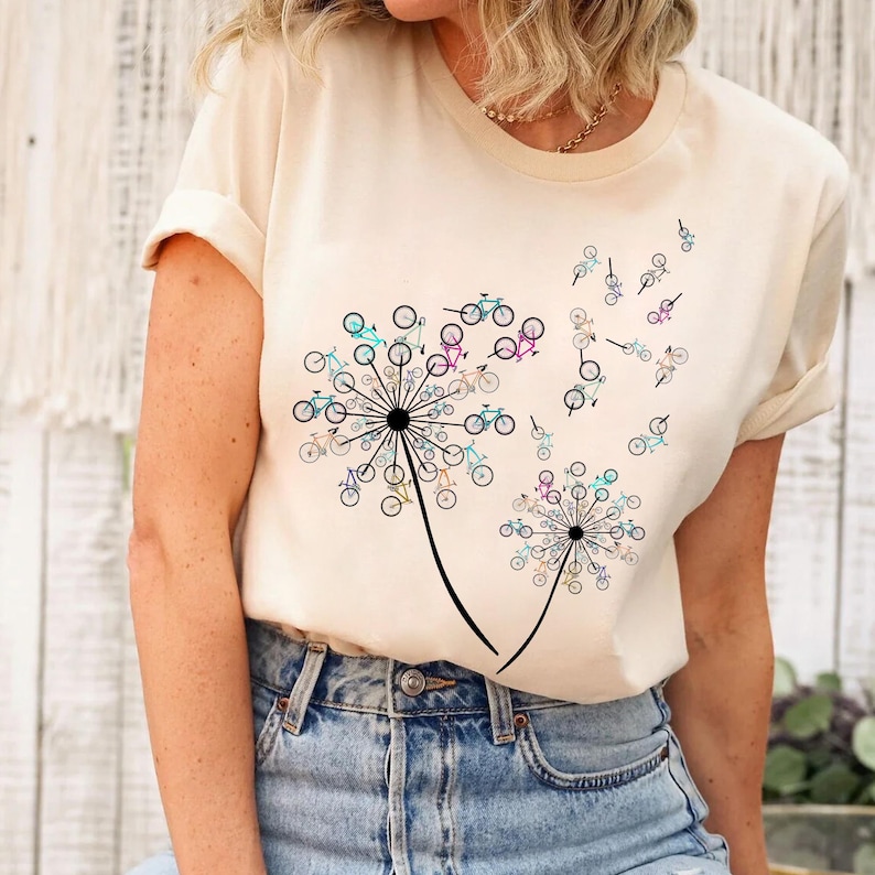 a woman wearing a t - shirt with a dandelion design