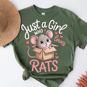 A green t-shirt with a cartoon image of a mouse in a cardboard box, along with the text "Just a Girl Who Loves Rats" printed on it.