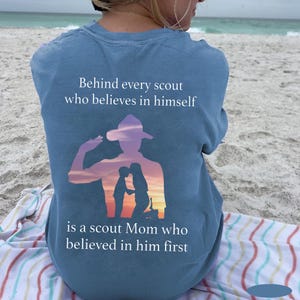 May include: A blue t-shirt with a silhouette of a scout saluting, with the text "Behind every scout who believes in himself is a scout Mom who believed in him first."