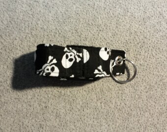 Black fabric with white skull and crossbones inhaler case
