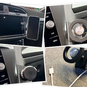 Peut inclure: Un smartphone noir monté sur le tableau de bord d'une voiture à l'aide d'un support magnétique. Le support est noir et argenté, avec un design circulaire. L'intérieur de la voiture est visible, avec des boutons et un écran.