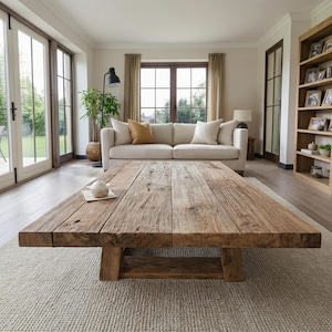 May include: A large, rectangular, reclaimed wood coffee table with a distressed finish. The table is the focal point of a living room. The table measures approximately 240 cm in length and 100 cm in width, with a natural, aged appearance.