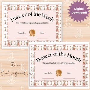May include: Two pink and white certificates for dancers. The top certificate reads "Dancer of the Week" and the bottom certificate reads "Dancer of the Month". Both certificates have a ballet shoe border and a gold seal.
