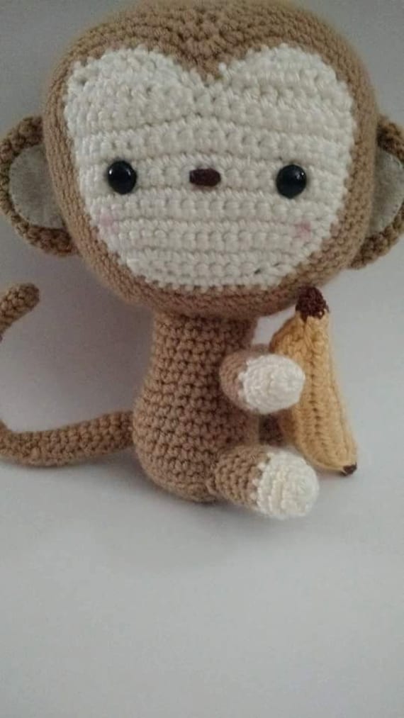 stuffed monkey holding a banana