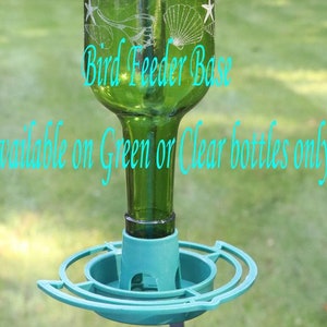 May include: A green glass bottle bird feeder base with a teal plastic tray attachment. The bottle features etched white designs of seashells and starfish. Text on the image reads: Bird Feeder Base. Available on Green or Clear bottles only.