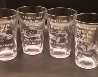 A Man's home may be his castle, but a Garage is his sanctuary.  Etched Pub, Wine or Rocks Glasses Set Of 2