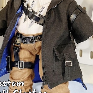 May include: Custom doll clothes featuring a black coat with a zipper, brown pants, a white shirt, and black boots. The doll is wearing a blue undershirt and has a black belt with silver knives.