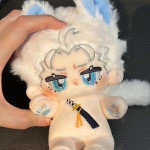 May include: White plush toy with blue ears and paws. The toy has a human-like face with blue eyes and a black sword embroidered on its chest.