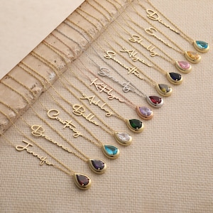 May include: A collection of gold and silver-toned metal necklaces, each featuring a delicate script name pendant and a single pear-shaped, multi-colored gemstone drop. The names include Diana, Emma, Shelly, Alyssa, Samantha, Serenity, Katelyn, Ashley, Bella, Courtney, Breanna, and Jennifer.