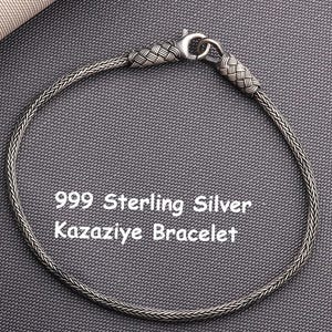 May include: A 999 sterling silver Kazaziye bracelet featuring a fine, woven chain design with a lobster claw clasp. The bracelet has textured, braided silver end caps and is displayed with the text 999 Sterling Silver Kazaziye Bracelet.