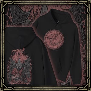 Puede incluir: Sudadera con capucha negra con una ilustración de lobo rojo dentro de un marco circular en la parte delantera. La parte trasera presenta un gráfico detallado en rojo y gris de una figura con capa y casco. La sudadera tiene capucha con cordón y bolsillo tipo canguro.