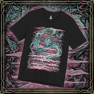 May include: A black short-sleeve t-shirt featuring a graphic print of a teal and white dragon with long whiskers and horns. The dragon is surrounded by horizontal pink cloud-like streaks. The design is centered on the chest of the garment.