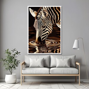 May include: A black and white zebra with black stripes drinks from a pool of water. The zebra's reflection is visible in the water.