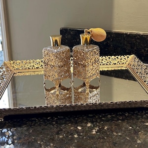 Mirrored vanity tray with filigreed perfume bottles