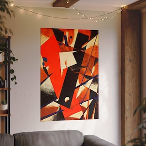 May include: Abstract art print featuring a bold composition of geometric shapes in red, black, white, and orange. The artwork includes angular lines and shapes, creating a dynamic visual effect. The print is mounted on a wall, adding a modern touch to the space.