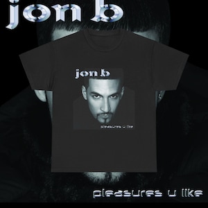 May include: A black t-shirt with a white graphic of Jon B. The graphic includes a photo of Jon B. and the text "Pleasures U Like".