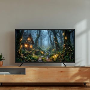 May include: A flat-screen TV displays a forest scene with a small cottage. The TV sits on a light wood cabinet with a small plant in a terracotta pot. A larger potted plant is to the right.