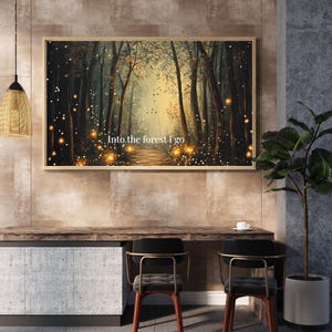May include: A framed art print depicting a forest scene with a path leading into the distance. The artwork features tall trees, a path, and glowing lights. The text "Into the forest I go" is at the bottom of the print.