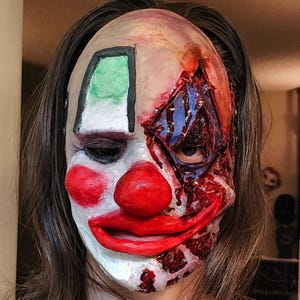 Clown mask. Burnt and bloody. Scary