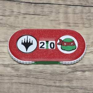 May include: A set of three ceramic mugs with a speckled, matte finish. Each mug features a different color: light blue, cream, and gray. The mugs have a simple, modern design and a comfortable handle.