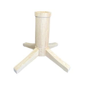 May include: A light-colored wooden table base with a cylindrical center and three angled legs. The base is unfinished, showing the natural wood grain. The legs are approximately 12 inches long.