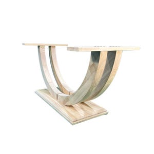 May include: A natural wood table base with a unique curved design. The base is made of two curved pieces of wood that are joined together in the middle. The base is supported by a rectangular platform.