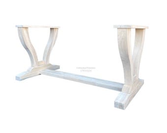 May include: Unfinished white wood table base with a trestle design. The base has two legs on each side, with a curved top and a square bottom. The base is made of solid wood and is ready to be stained or painted.