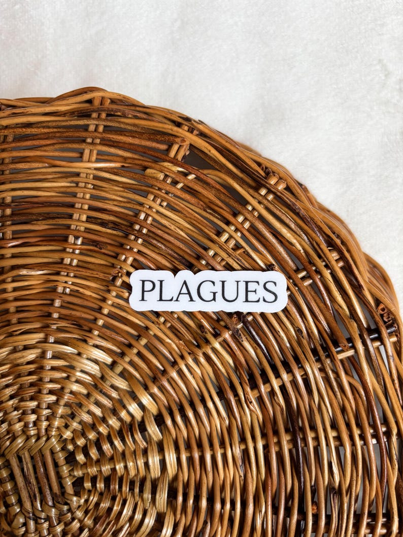 May include: A close-up of a woven wicker basket with a white sticker that says "PLAGUES" on it.
