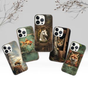 May include: Five different phone cases with nature-themed designs. The cases are all for the iPhone 13 Pro Max and feature a variety of animals and landscapes. The designs include a white horse in a forest, a goldfish in a pond, a cat peeking out from behind a tree, a fox in a forest, and a bee on a branch.